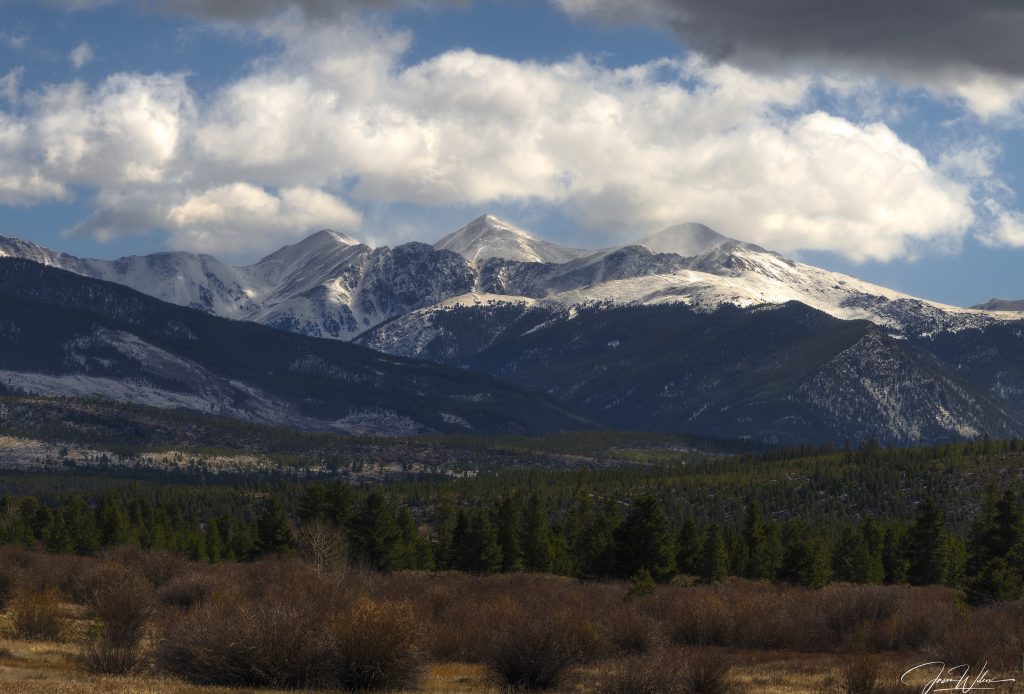 Colorado mountain landscape featuring Torreys Peak under dramatic clouds and alpine light