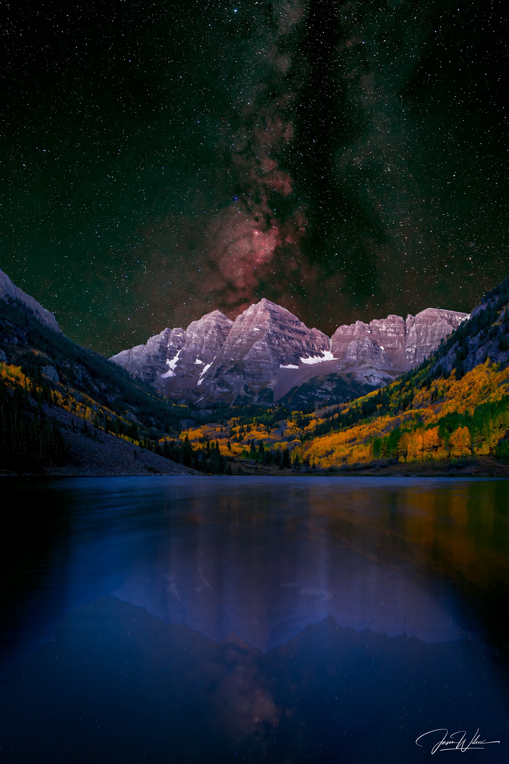 Maroon Bells reflected in a Colorado mountain lake with autumn color